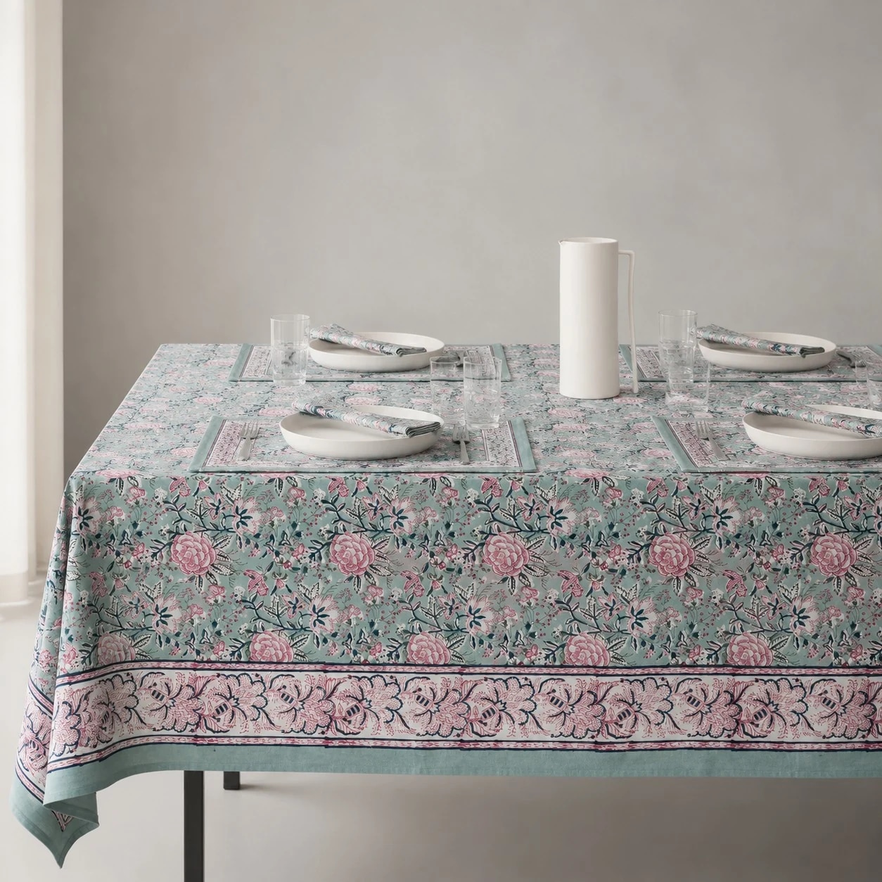 Sage green floral tablecloth on a dining table