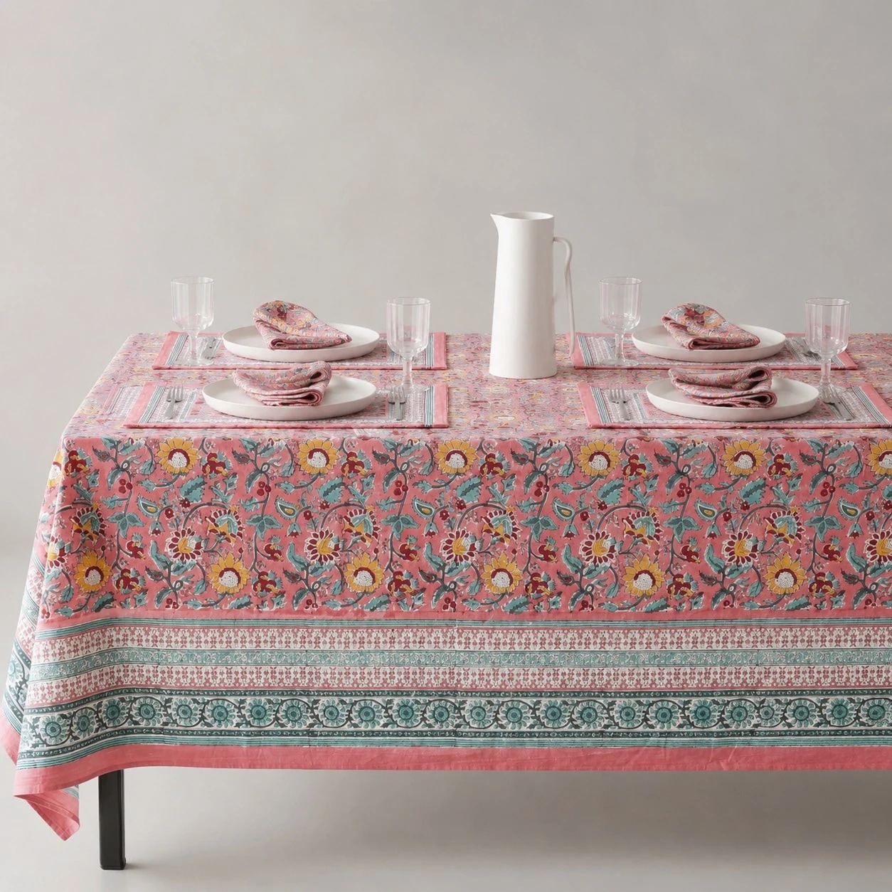 Pink garden border floral tablecloth on a dining table