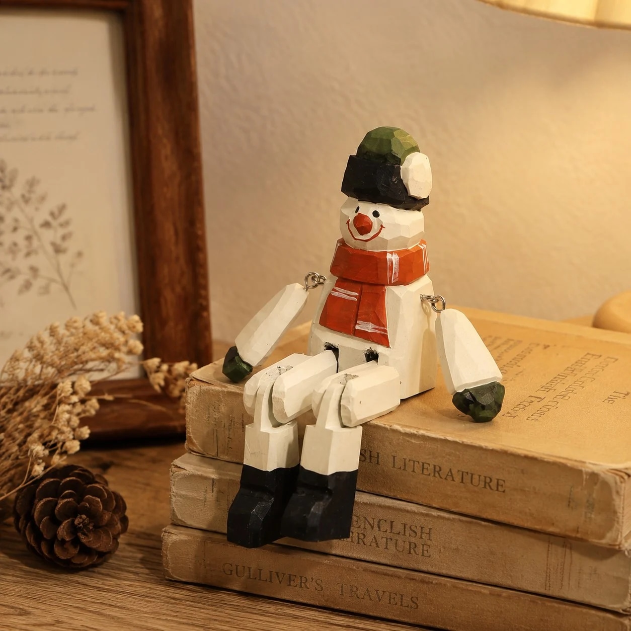 Hand-carved wooden santa snowman ornament styled on a tabletop edge