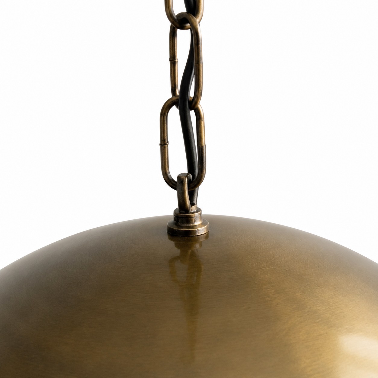 Close detail of the chain suspension and brass canopy
